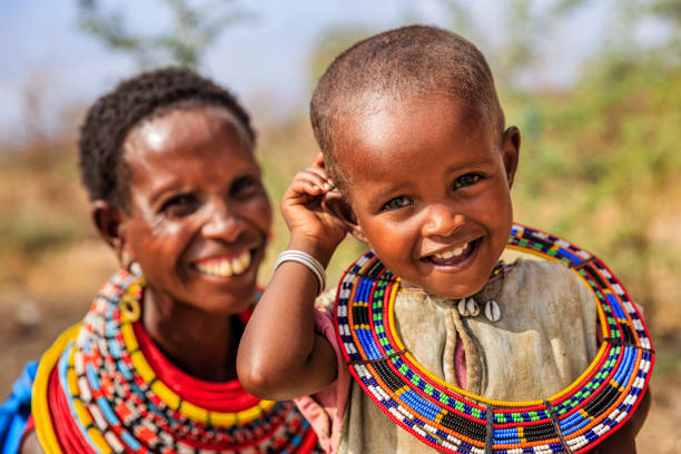 African mother from Samburu tribe sitting her baby , Kenya, Africa. Samburu tribe is one of the biggest tribes of north-central Kenya, and they are related to the Maasai.
